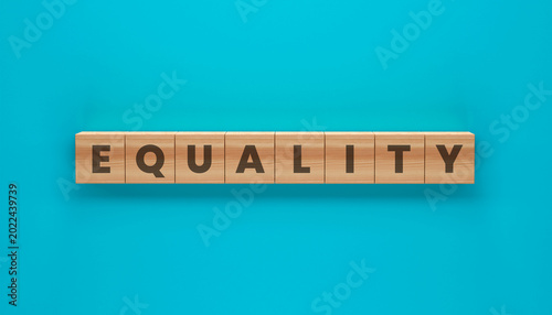 Photos Equality in Wooden Blocks: A bold message of equality spelled out in wooden blocks, set against a vibrant turquoise background