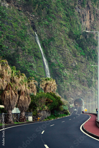 Scenic Coastal Road in Madeira with Waterfall and Tunnel Entry Madeira island, Portugal landscape