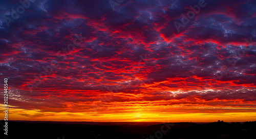 Vibrant Sunset Clouds Painting the Sky with Fiery Hues