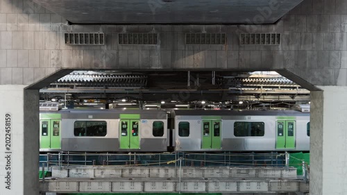 Tokyo Scene  :  Commuter Train Departing From Station Platform in a Framed View Between Concrete Highway Supports, Exposed Layered Structure of Urban Redevelopment  |  Shibuya Station, Tokyo, Japan