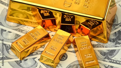 gold bars with dollar bills
