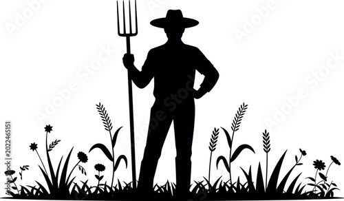 Bild auf Leinwand Black Silhouette of a Farmer Holding Pitchfork Standing in Rural Field with Gras