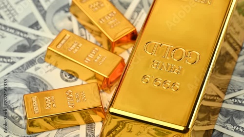 gold bars with dollar bills