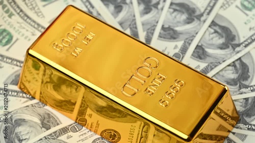 gold bars with dollar bills