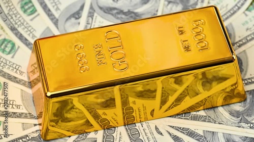 gold bars with dollar bills