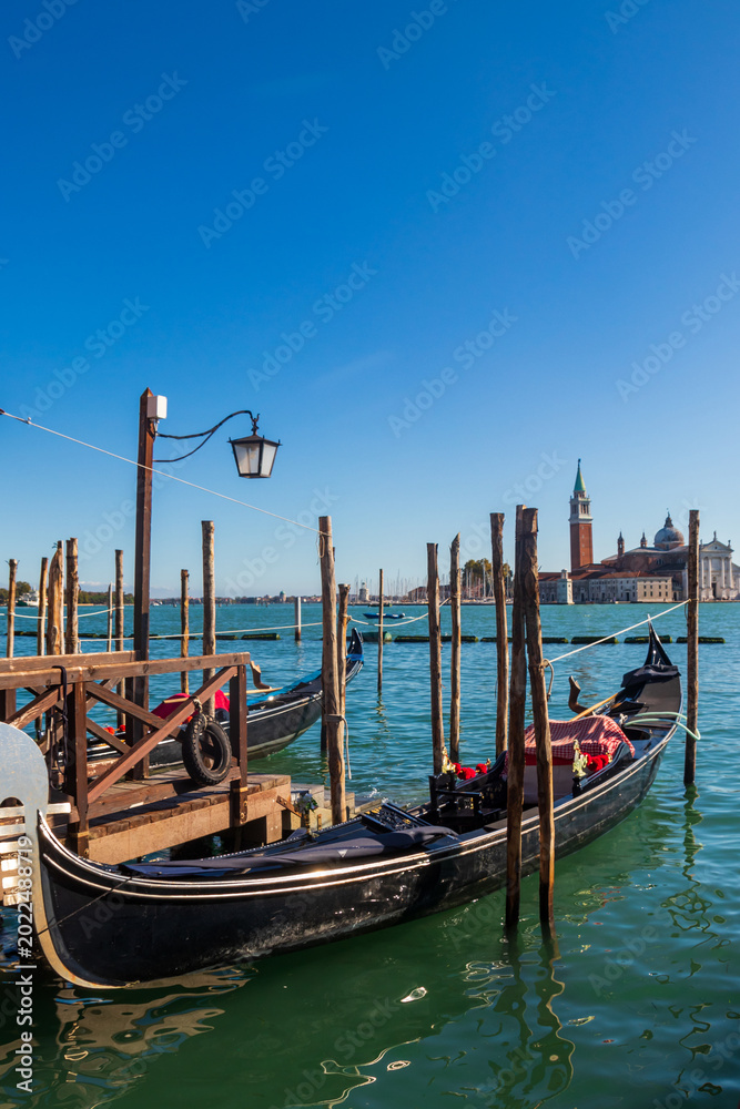 Obraz premium Traditional Venetian Gondolas Moored at Molo San Marco with San Giorgio Maggiore Island in the Background, Venice, Italy