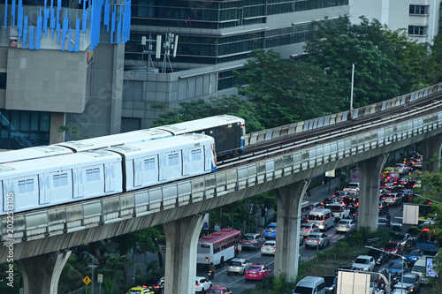 Top view of a BTS Skytrain on elevated rails in Silom district. A Silom Line BTS Skytrain traveling along its  elevated track bed high above busy Ratchadamri Road.