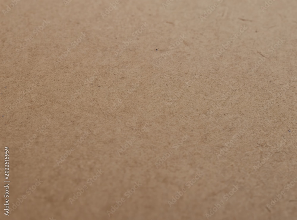 Fototapeta premium Closeup of textured brown paper surface. Natural organic fibers create a warm matte background with subtle grain and detail. Ideal for rustic crafts or vintage design elements.