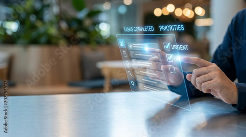 Hand interacting with futuristic digital dashboard interface on tablet