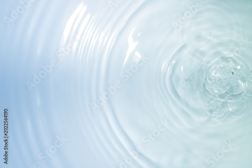Soft Blue Water Surface with Gentle Ripples and Bubbles in Focus