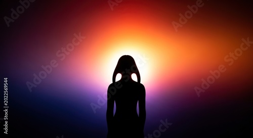 Silhouette of a person against a vibrant colorful background.
