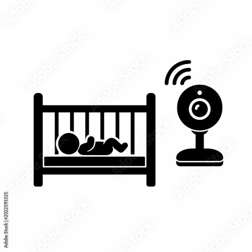 Baby sleeping in crib with baby monitor