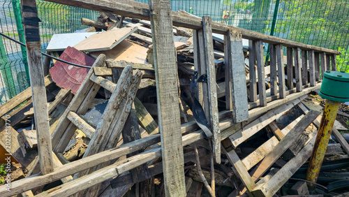 Fényképezés Large pile of old weathered wooden planks, boards and construction debris stacke