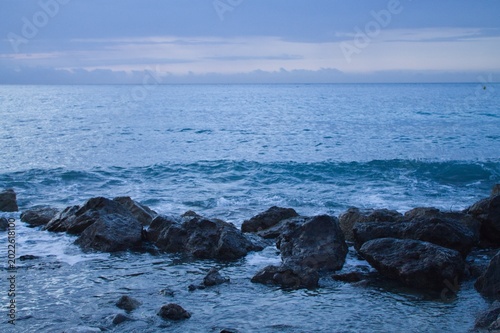 Mediterranean Sea view from Cap Martin with distant mountains and calm water, morning atmosphere