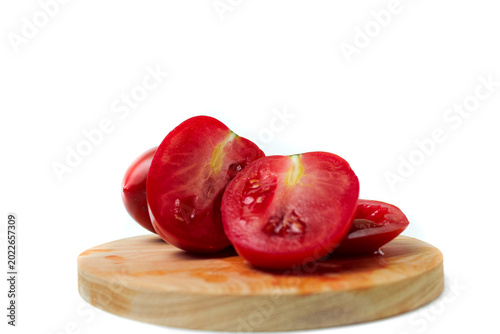 Tableau sur toile Halved tomatoes on wooden board isolated on white background