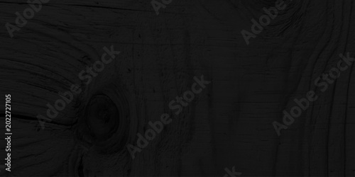 Foto Black charred wood texture background with natural organic grain and knots, dark