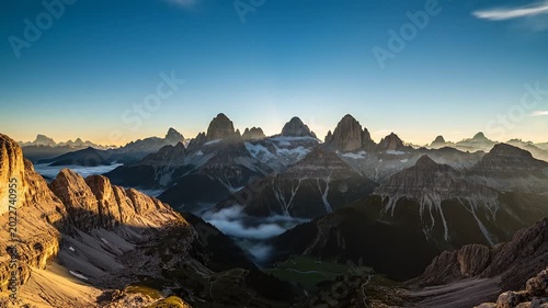 Sunrise over rugged mountain landscape peaks.