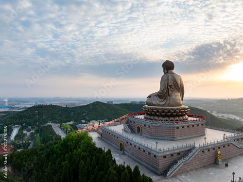 Obraz na płótnie The Great Buddha of Nanshan Mountain in Shandong at sunrise viewed from aerial p