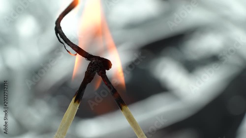 4K macro video of burning matchsticks with glowing flames and detailed charred tips.