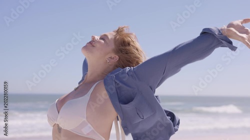 Carefree woman with freckles on cheeks enjoy tropical beach