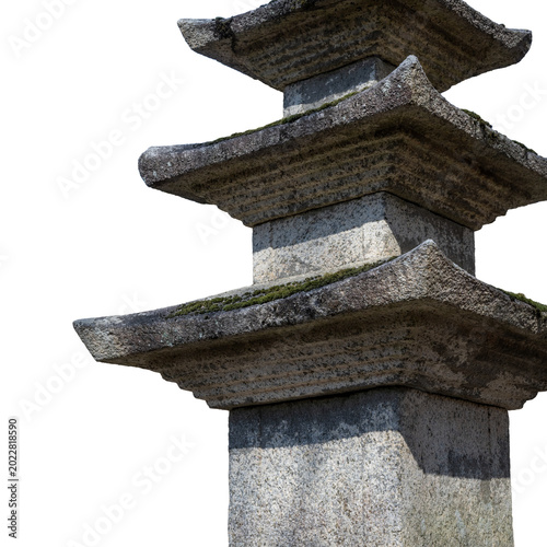 Partial view of a traditional Korean multi story stone pagoda isolated on a white background