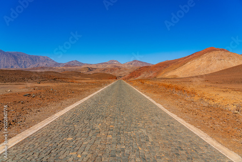 Konstfotografi A wide panoramic view of an inhospitable place with an endless road in the center of frame, Santo Antão, Cape Verde