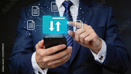 Cloud storage and file transfer management on mobile phone, businessman uploading and downloading documents, digital data synchronization, remote access to files, wireless