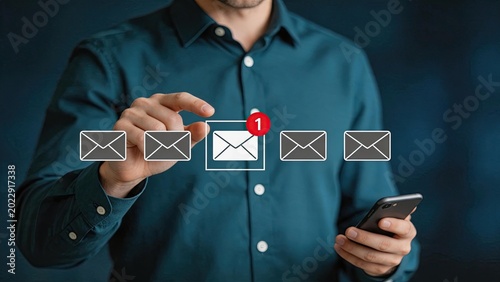 Email notification and inbox management concept, businessman touching digital envelope icon with red badge indicating one new message on mobile device