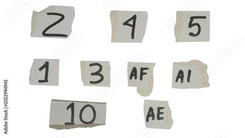 Torn paper pieces with numbers and letters scattered around