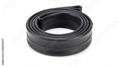 Coiled black rubber seal strip on white background