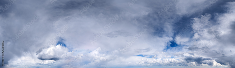 Obraz premium Dramatic Cloudscape Panorama of Rolling Storm Clouds and Soft Blue Sky Over Horizon