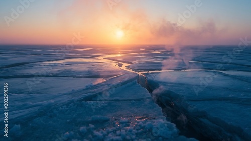 Geothermal steam escaping through cracked Arctic sea ice