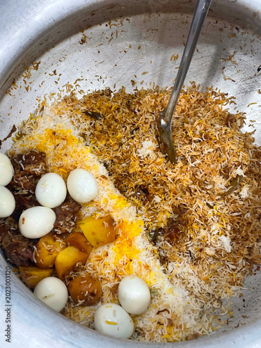 traditional rice dish with eggs and meat cooked in large pot ready to serve