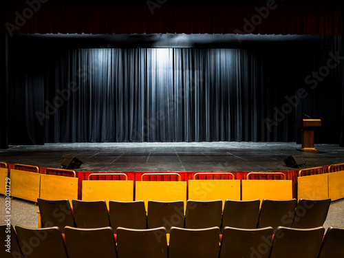 Cuadro en lienzo An empty dark theater stage with a wooden podium wooden partitions and rows of u