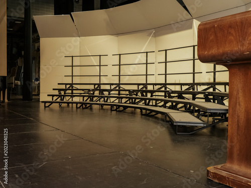 Tableau sur toile An empty dark performance stage equipped with metallic choir risers portable tie