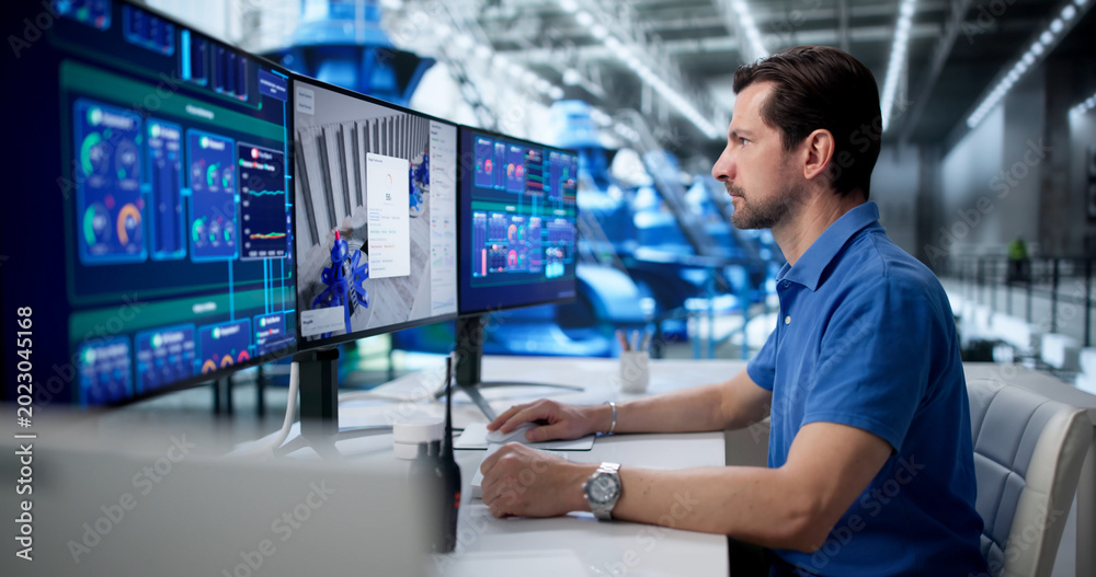 Fototapeta premium Man Uses SCADA Software To Monitor Clean Energy Production