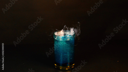 Photos Dry Ice Sublimating in a Glass Jar of Bubbling Blue Liquid