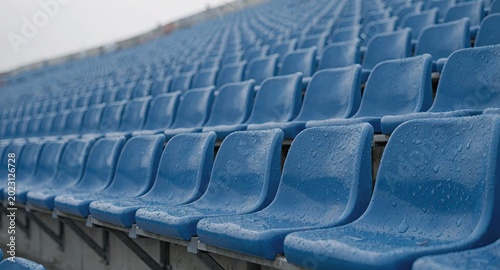 Rows of empty blue stadium seats in sports arena