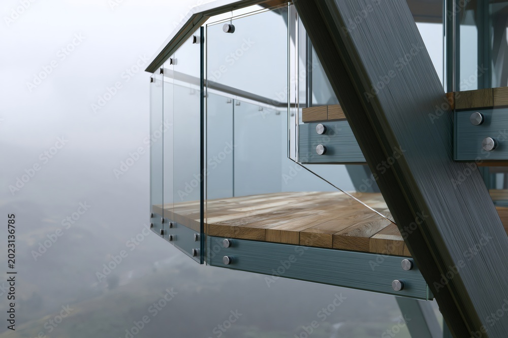Fototapeta premium Modern glass balcony overlooking foggy mountain landscape