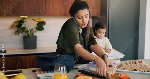 Foto Daughter, lunch and phone call with mother packing in kitchen for multitasking or preparation