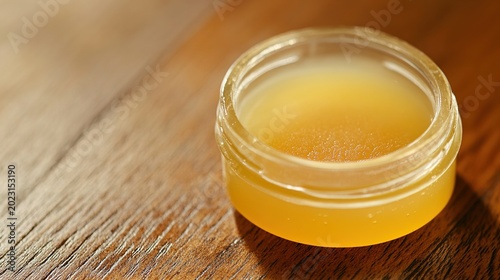 substance. A gelatinous, opaque disk floating in a clear glass jar on a wooden table. STEM education sheets, lab safety posters, designed for STEM education and laboratory safety posters.