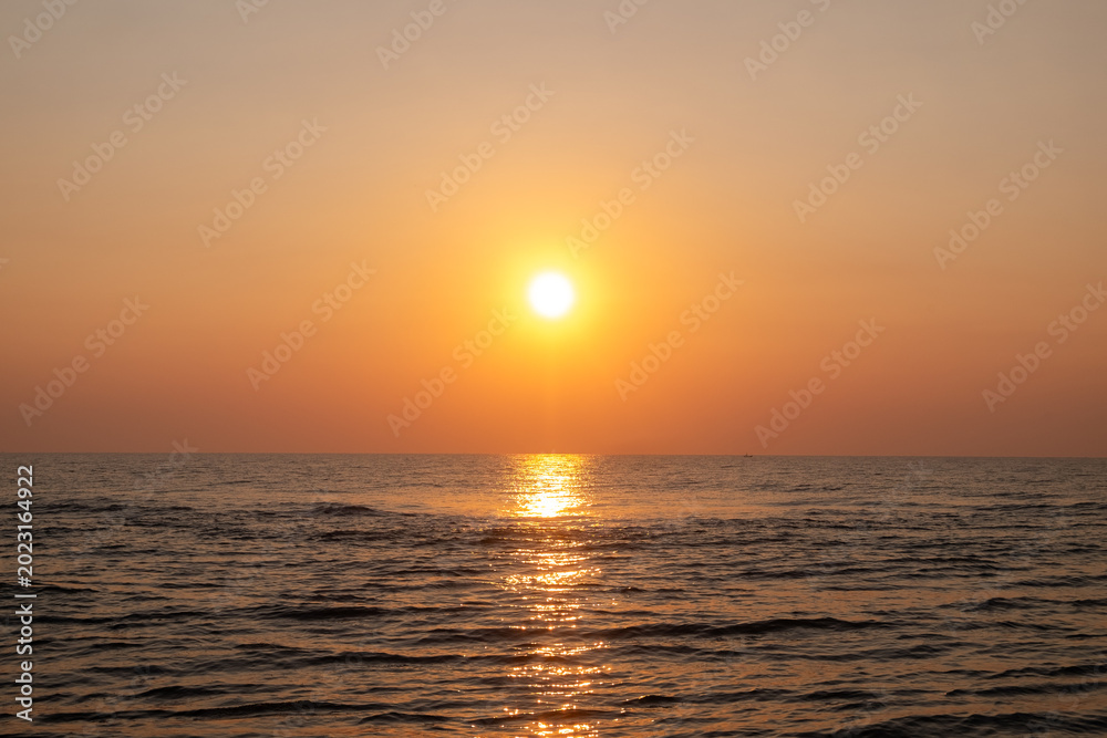 Fototapeta premium Beautiful sunset over the sea. The sun goes down over the sea.