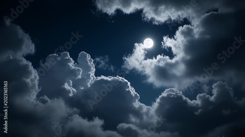 Cinematic full moon in night sky with dramatic slow moving clouds