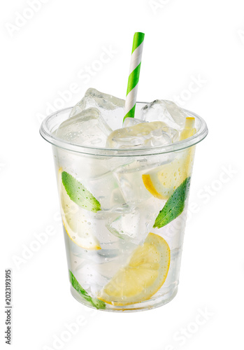 Lemonade in transparent disposable plastic cup with ice, lemon slices and fresh mint leaves isolated on white background