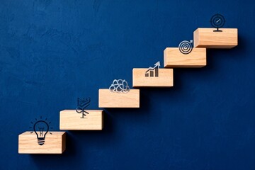 Wooden blocks with icons on blue background