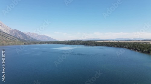 Aerial fast 180 degree panoramic drone view of Jenny Lake and Teewinot Mountain Grand Teton Wyoming