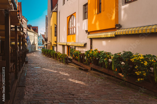 Empty Cobblestone Street with Outdoor Cafe Terraces in Tallinn