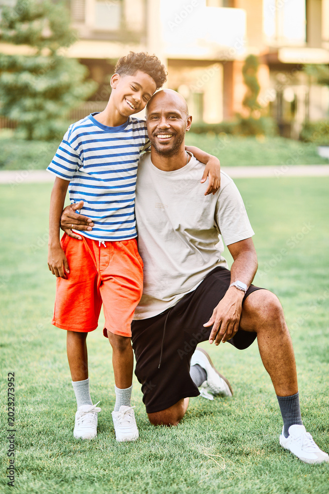 Fototapeta premium Portrait of father and son having fun outdoors in park or nature,, family life, parenting, love and bonding concepts