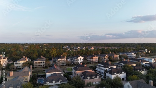 Photos Aerial view of luxury houses in Houston, Woodlands by the lake with dramatic clo