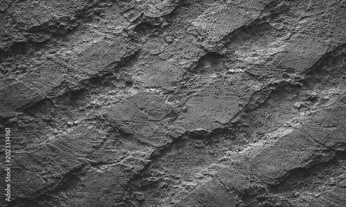 Dark slate stone texture background, rugged charcoal rock surface with diagonal ridges, natural grey granite wall material for architectural design